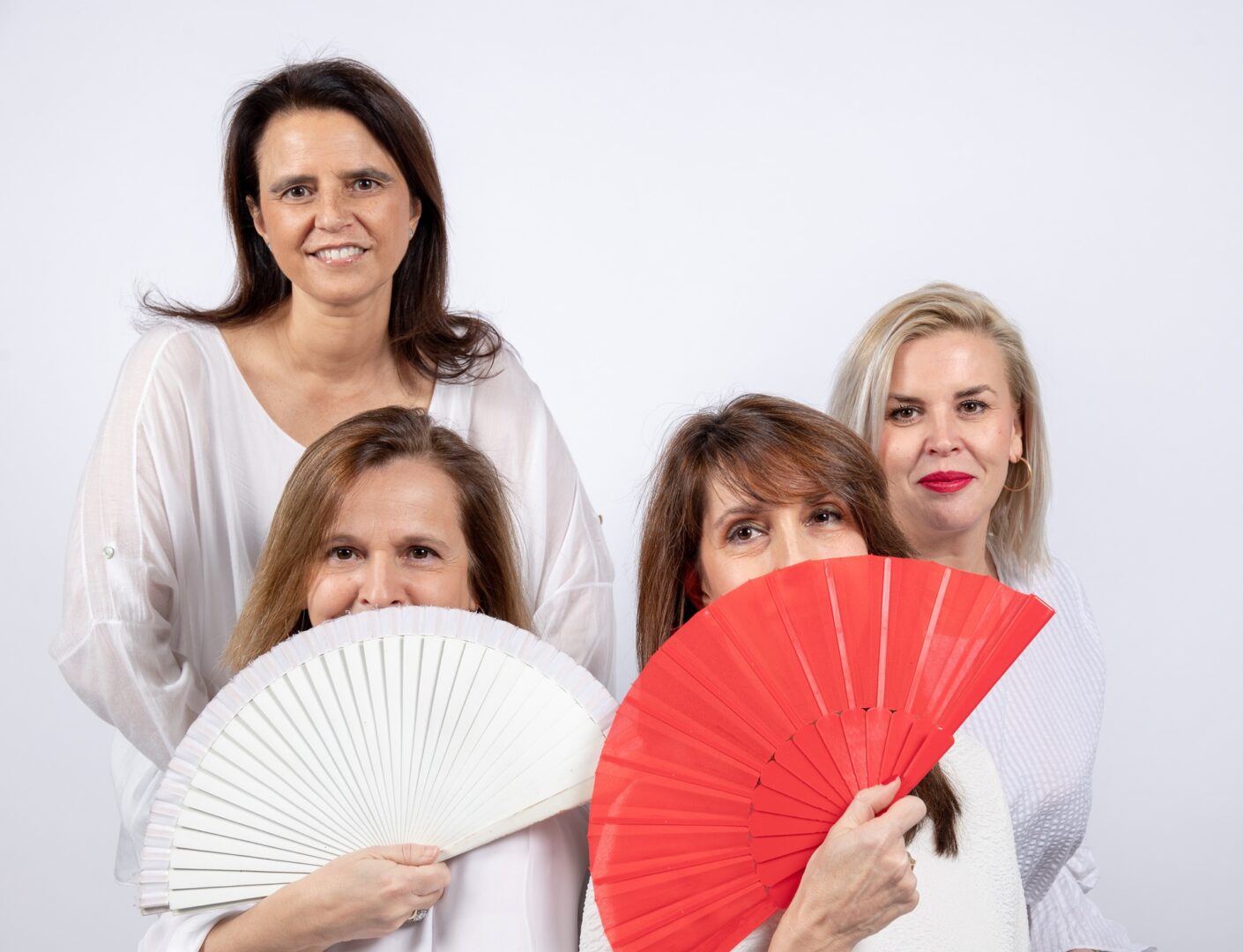 businesswomen with fans looking at camera